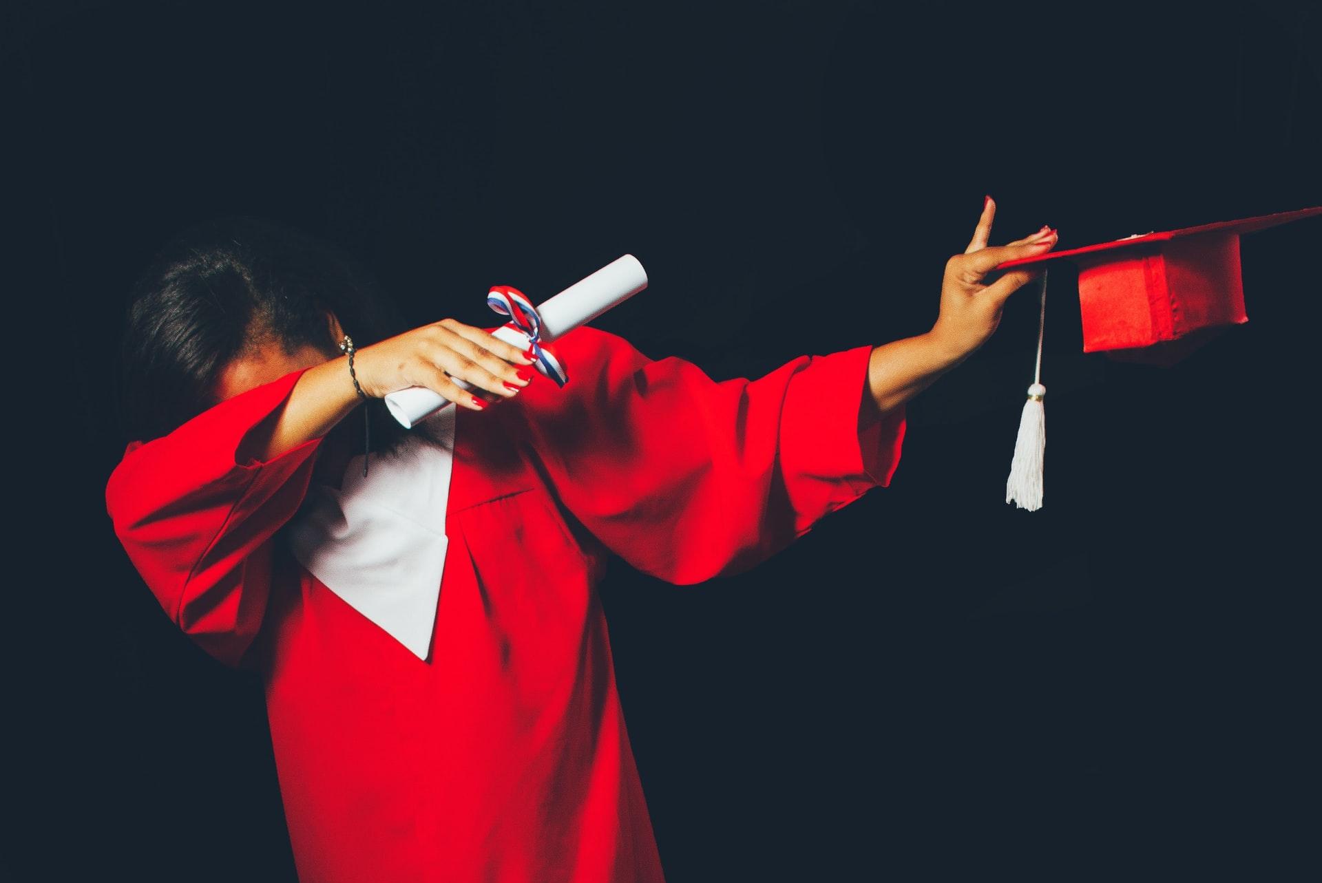 person wearing red graduation dress